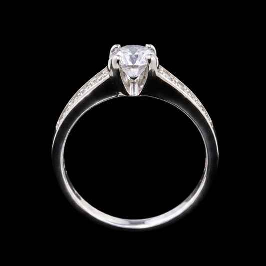 A silver ring with a round-cut CZ stone at its center, set against a plain background.