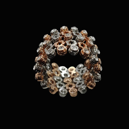 A ring with a geometric design and round-cut CZ stones in silver and gold-tone