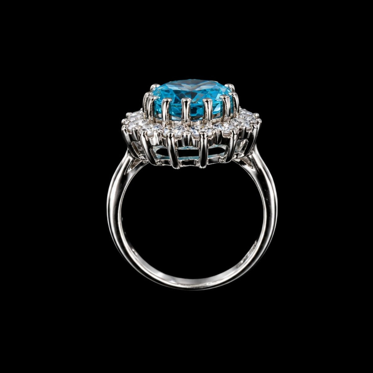 A silver ring with a large blue gemstone in the center, set against a gray background.