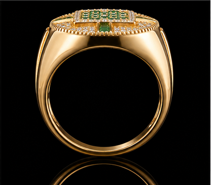 A gold ring with an emerald stone and CZ stones on a black background