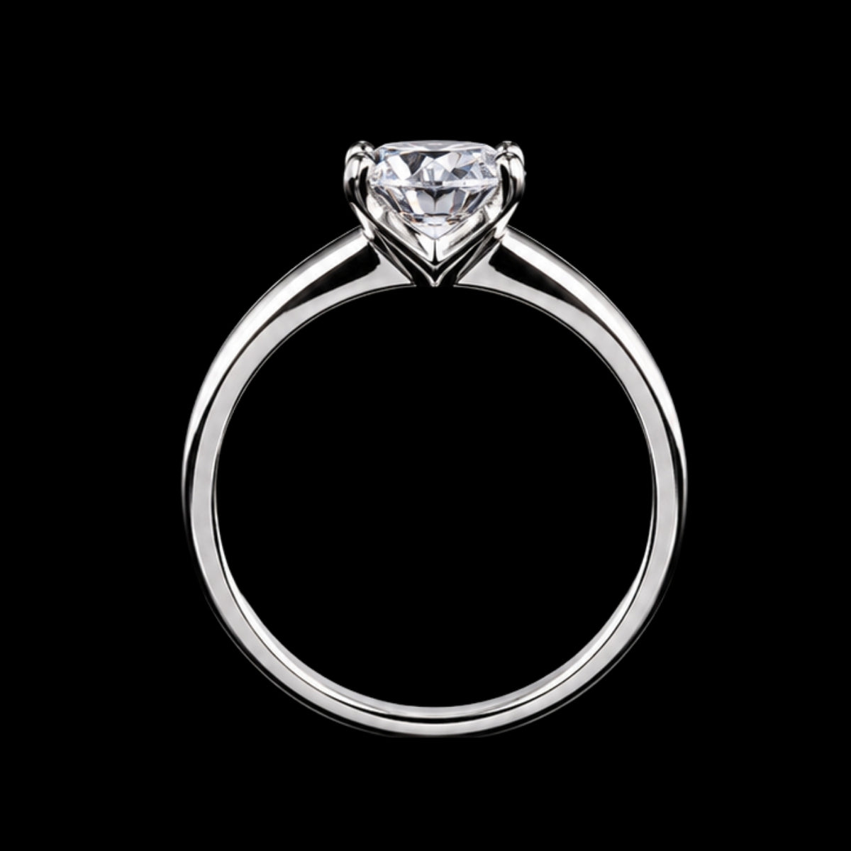 A silver ring with a large diamond in the center, set in a simple band.