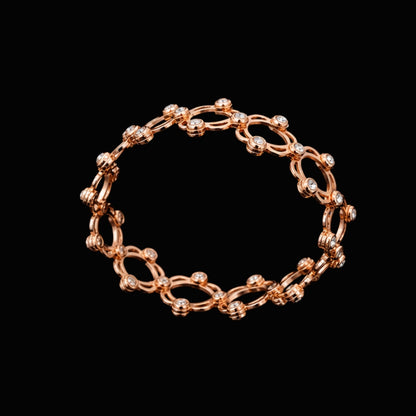 A rose gold chain link bracelet with CZ stones