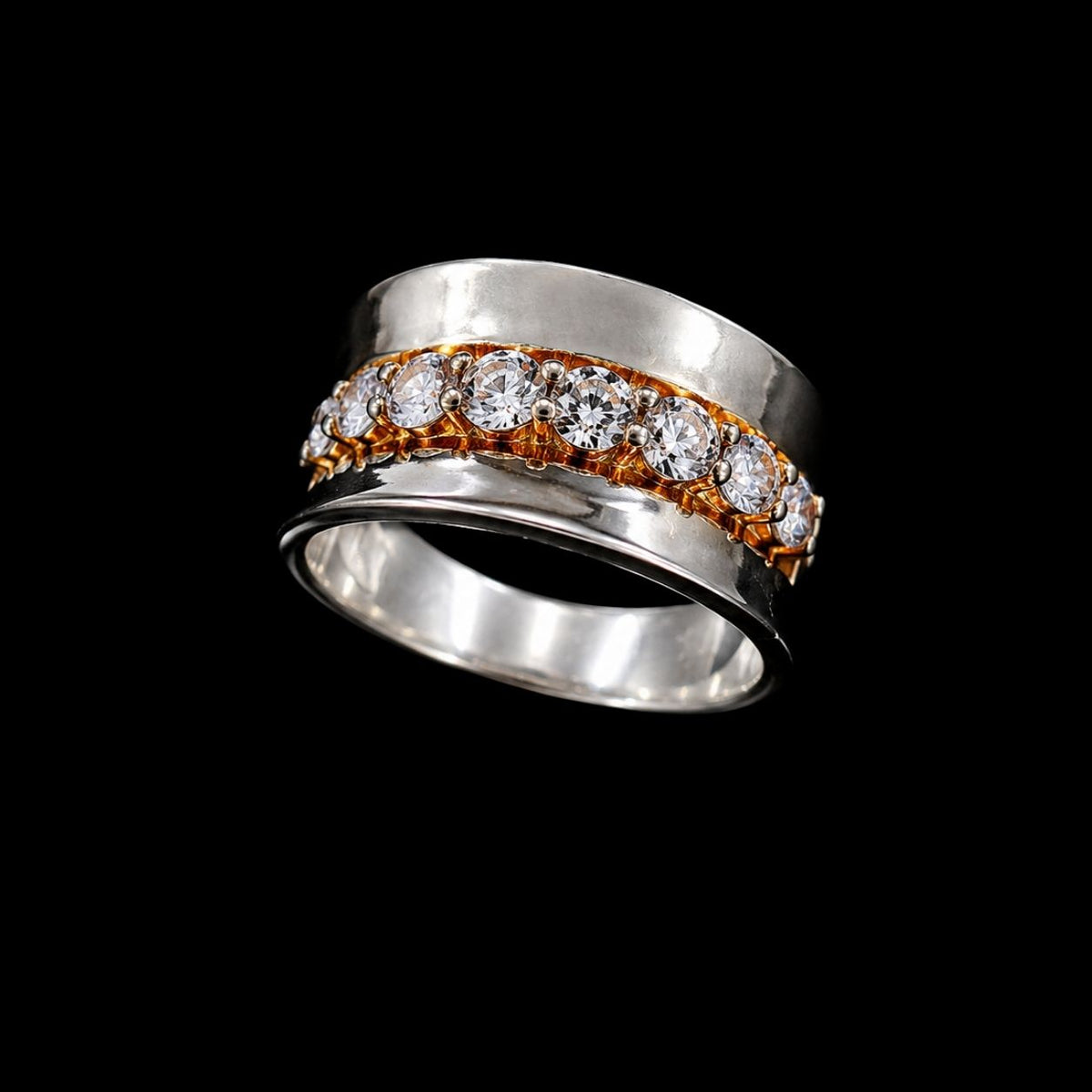 A silver ring with a gold-tone CZ stone detail.