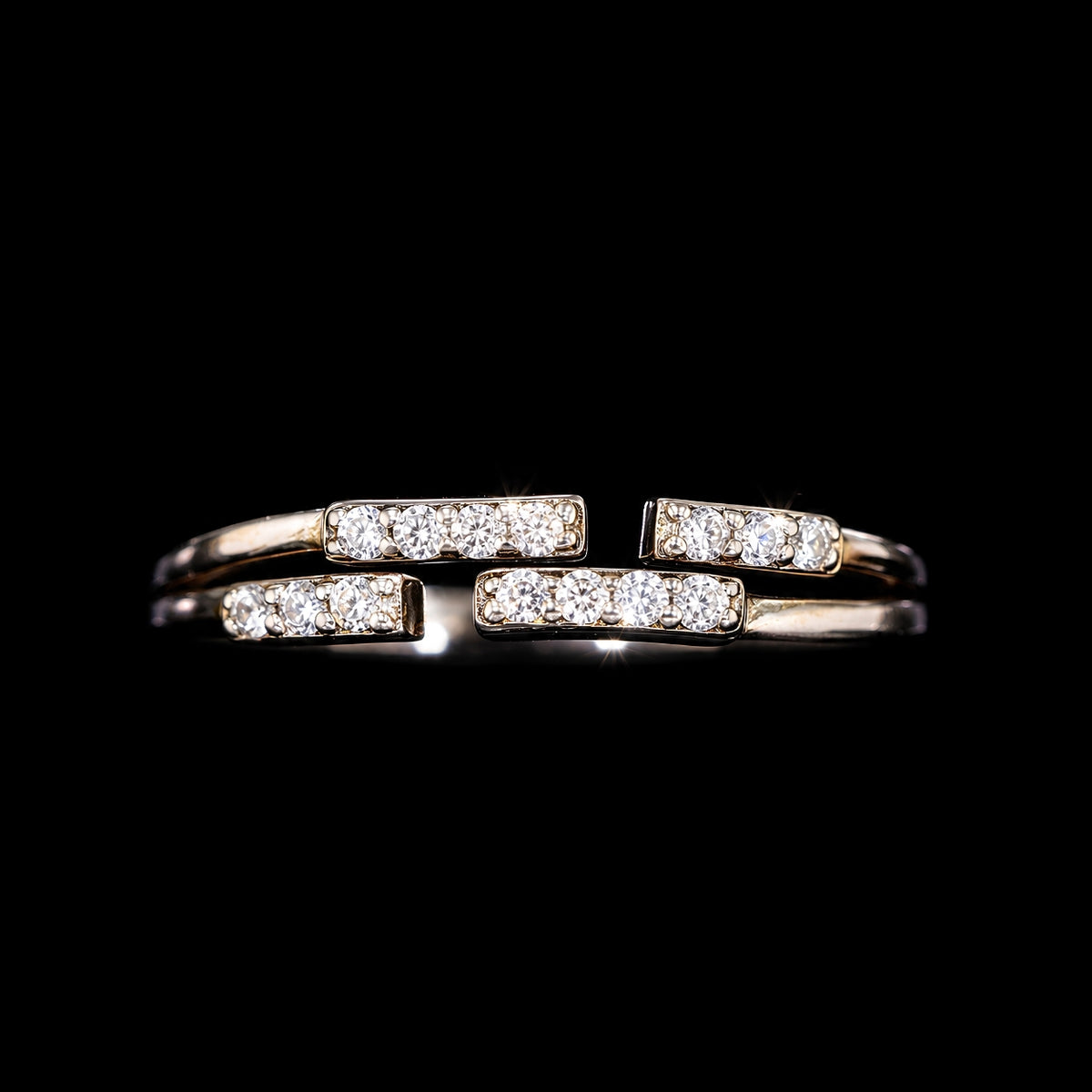 A gold-tone ring with three bars and CZ stones.