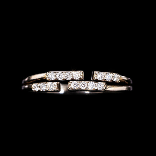 A gold-tone ring with three bars and CZ stones.