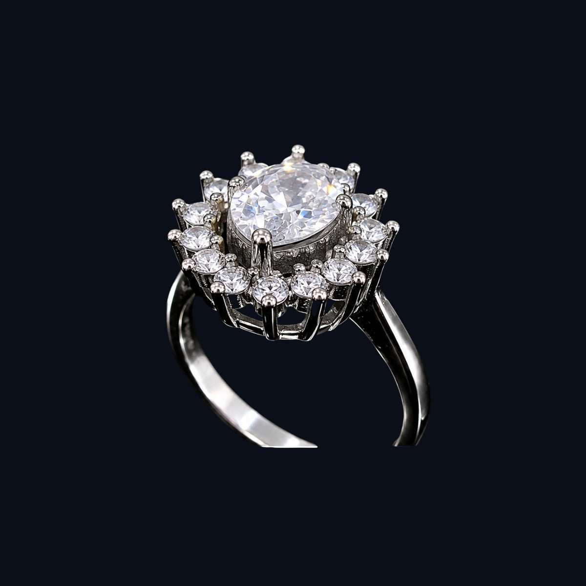 A silver ring with a large oval-cut clear cubic zirconia stone surrounded by smaller round-cut stones, set in a delicate silver band.