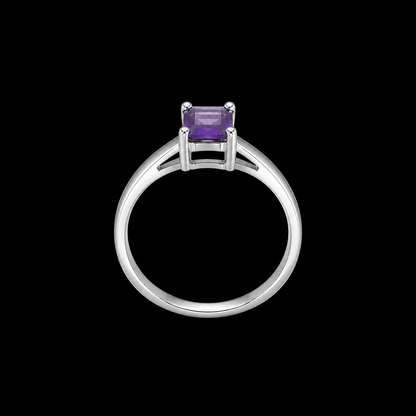 A silver ring with a purple gemstone on a black background