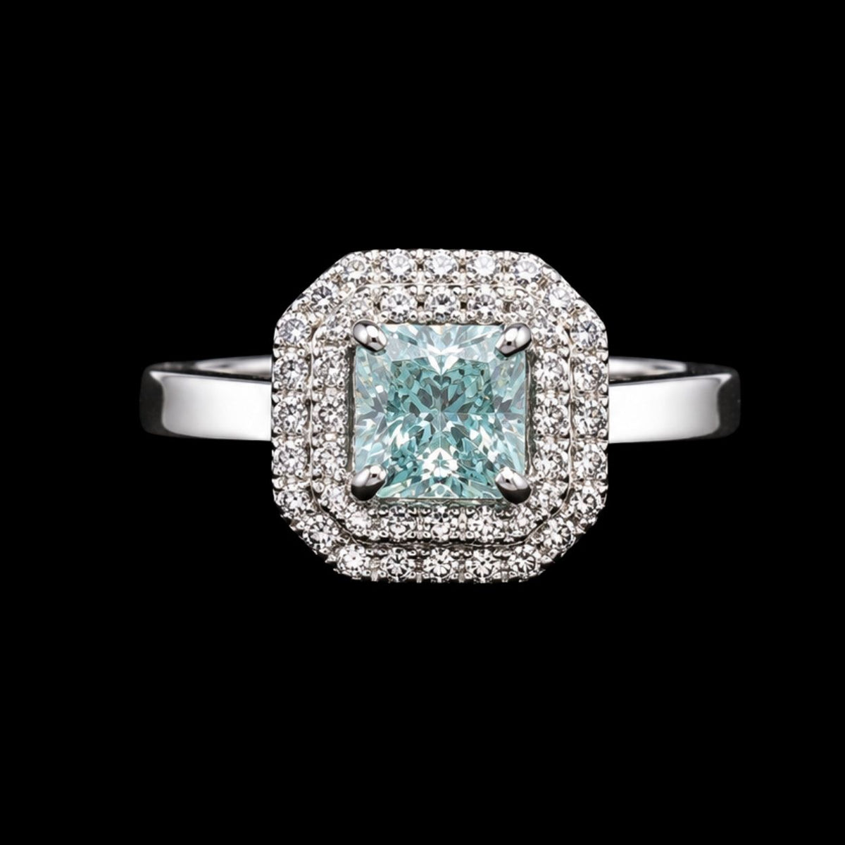 A square halo ring with a large light blue gemstone and clear gemstones in a silver-tone metal