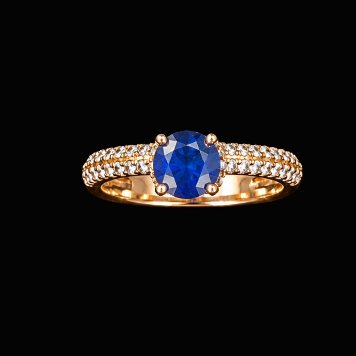 A gold-tone ring with a round-cut blue CZ stone.