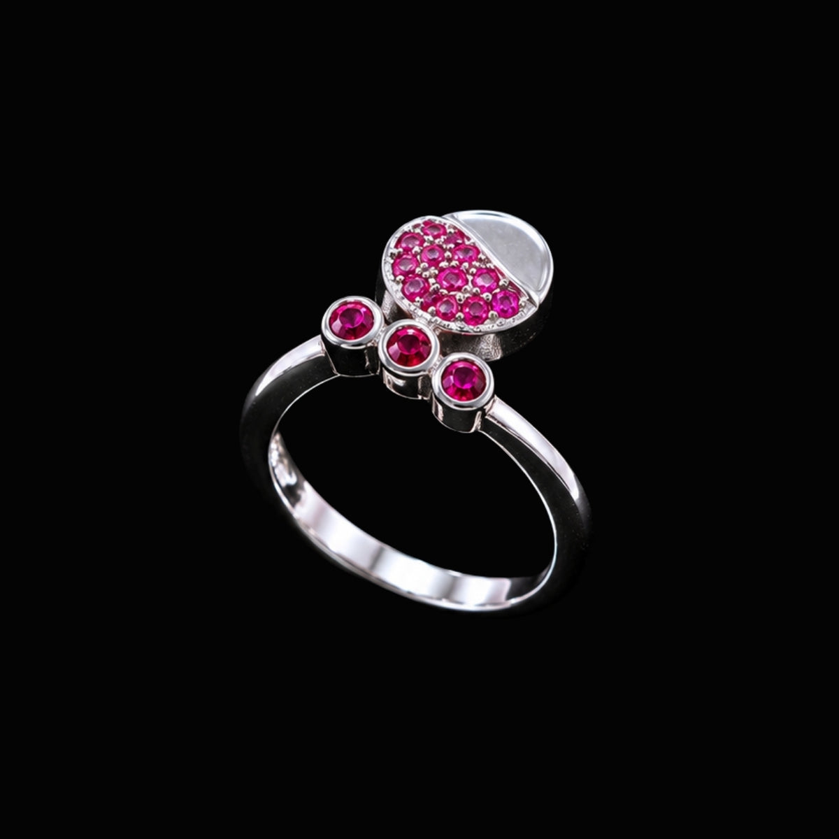 A silver ring with a cluster of small, round pink CZ stones.