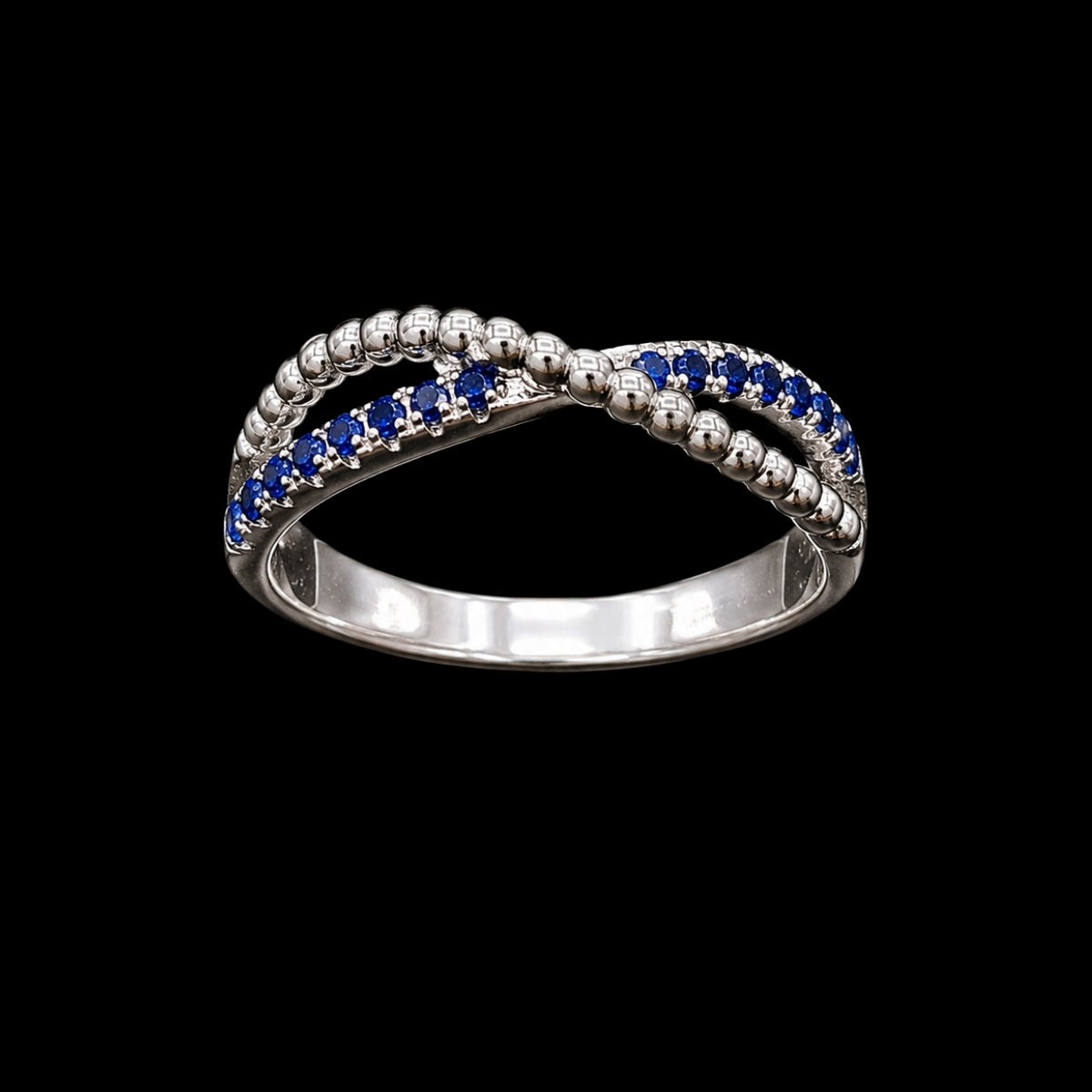 A silver ring with a beaded design and blue CZ stones.