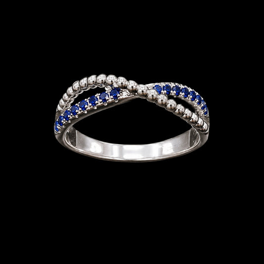 A silver ring with a beaded design and blue CZ stones.