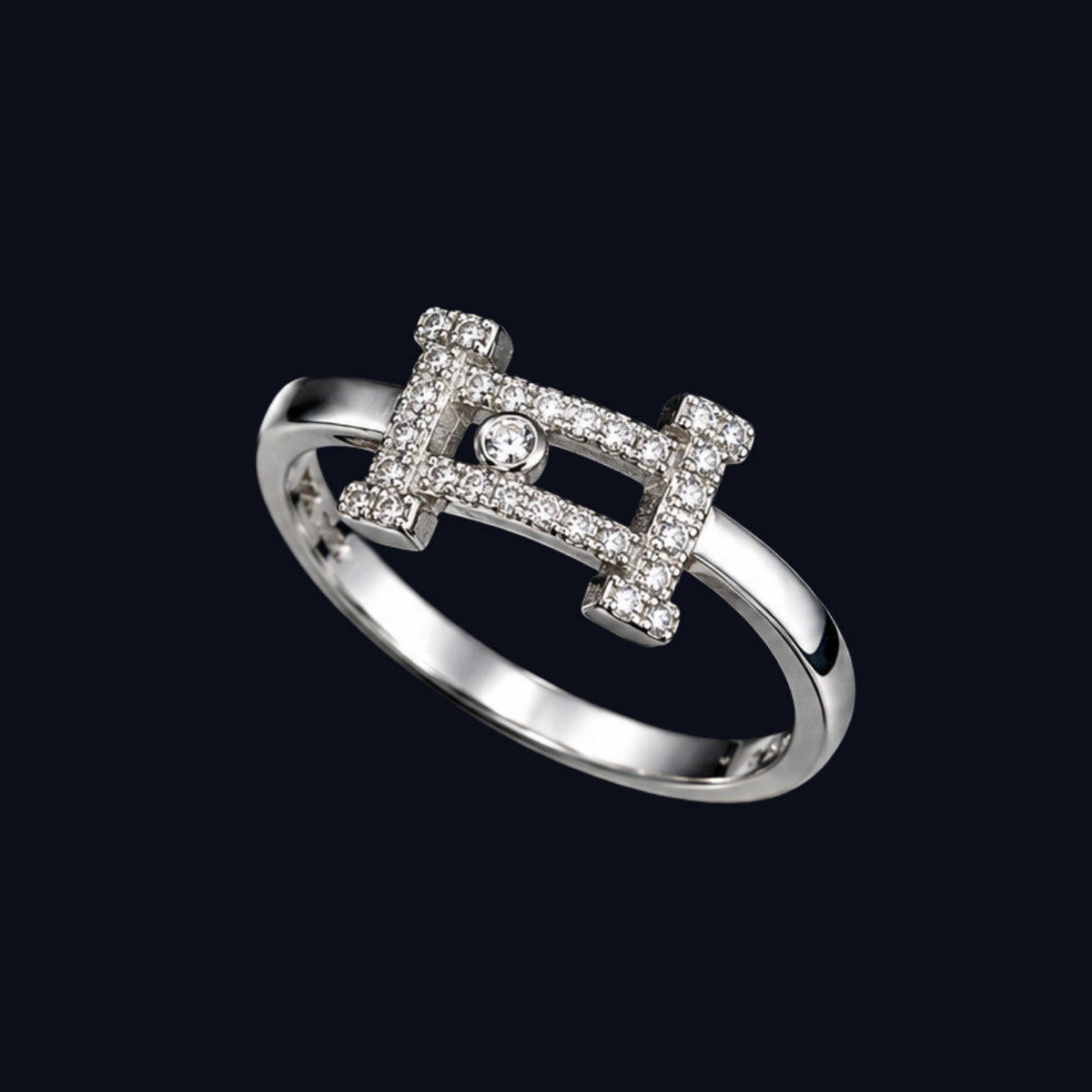 A silver-tone ring with a geometric design and clear cubic zirconia stones.