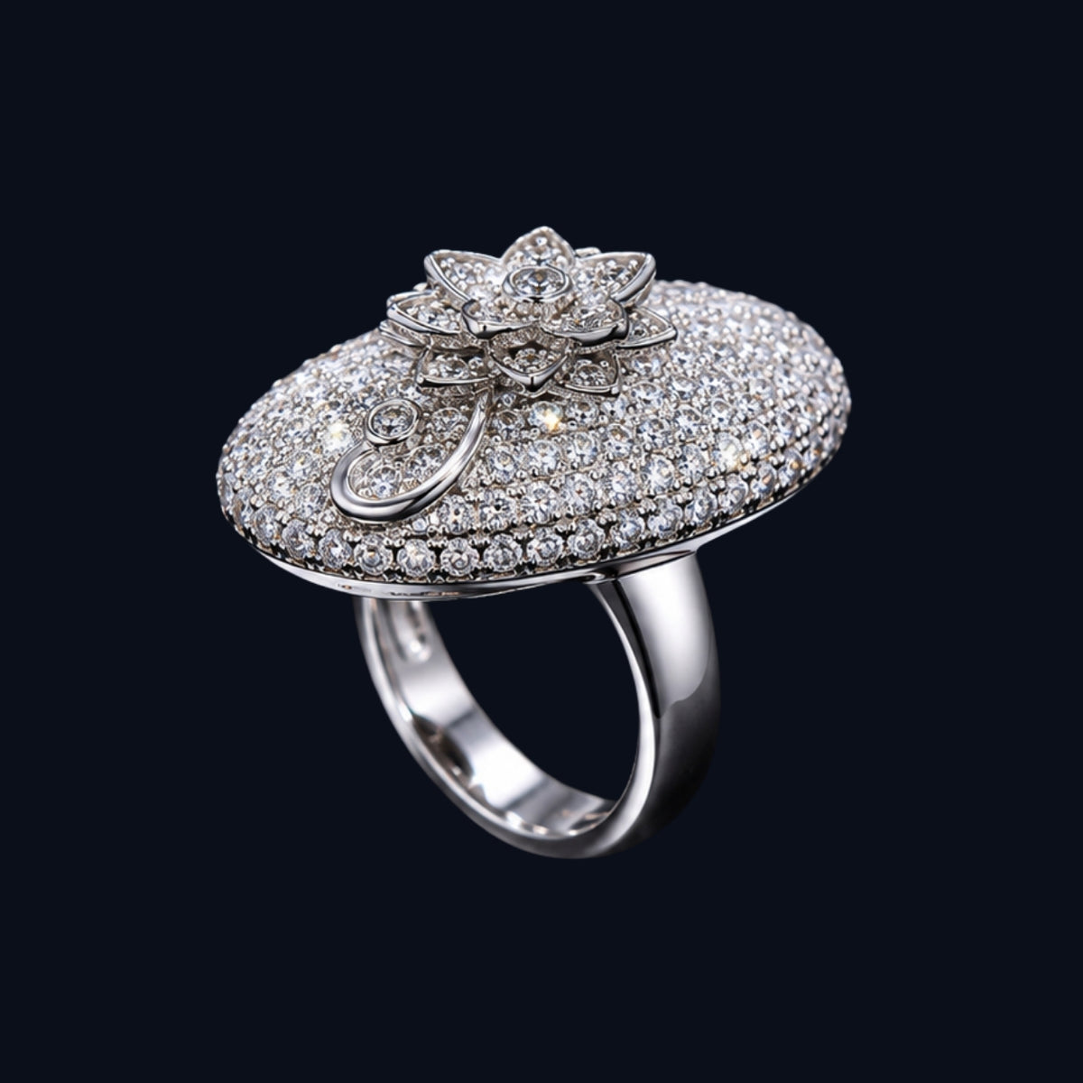 A silver ring with an oval shape and a floral motif, featuring CZ stones.
