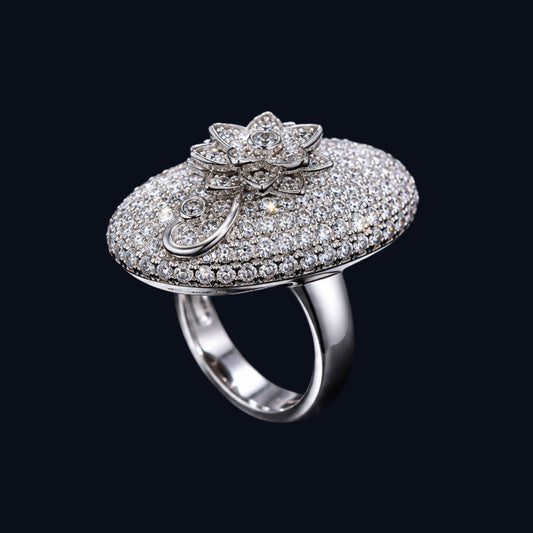 A silver ring with an oval shape and a floral motif, featuring CZ stones.
