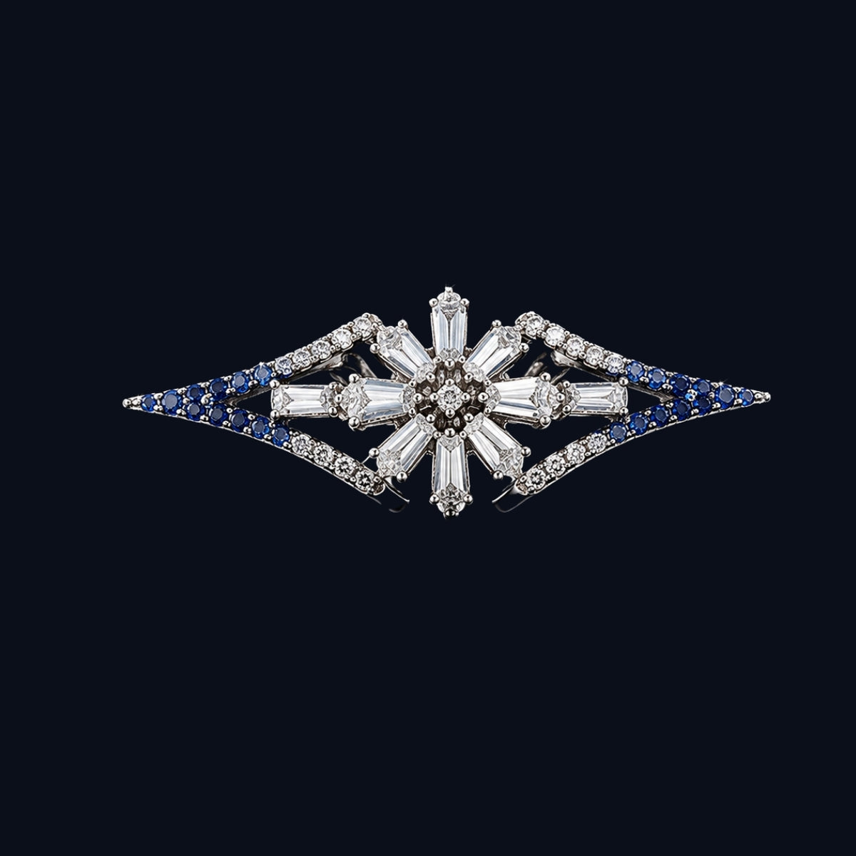 A starburst design ring with a central cluster of baguette and round-cut clear cubic zirconia stones, set in a silver-tone metal.