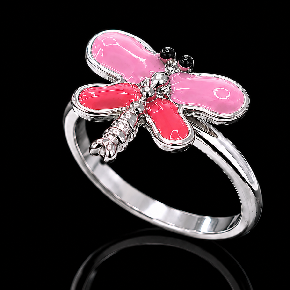 A silver ring with a pink dragonfly design and enamel details.