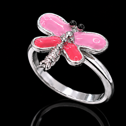 A silver ring with a pink dragonfly design and enamel details.